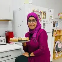 A Happy Days staff member serving a treat