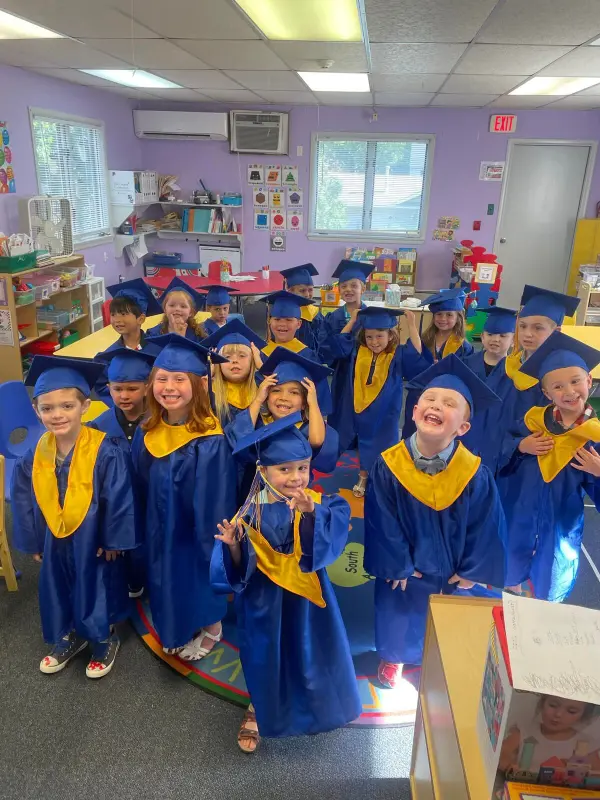 Happy Days Pre-K graduates in caps and gowns